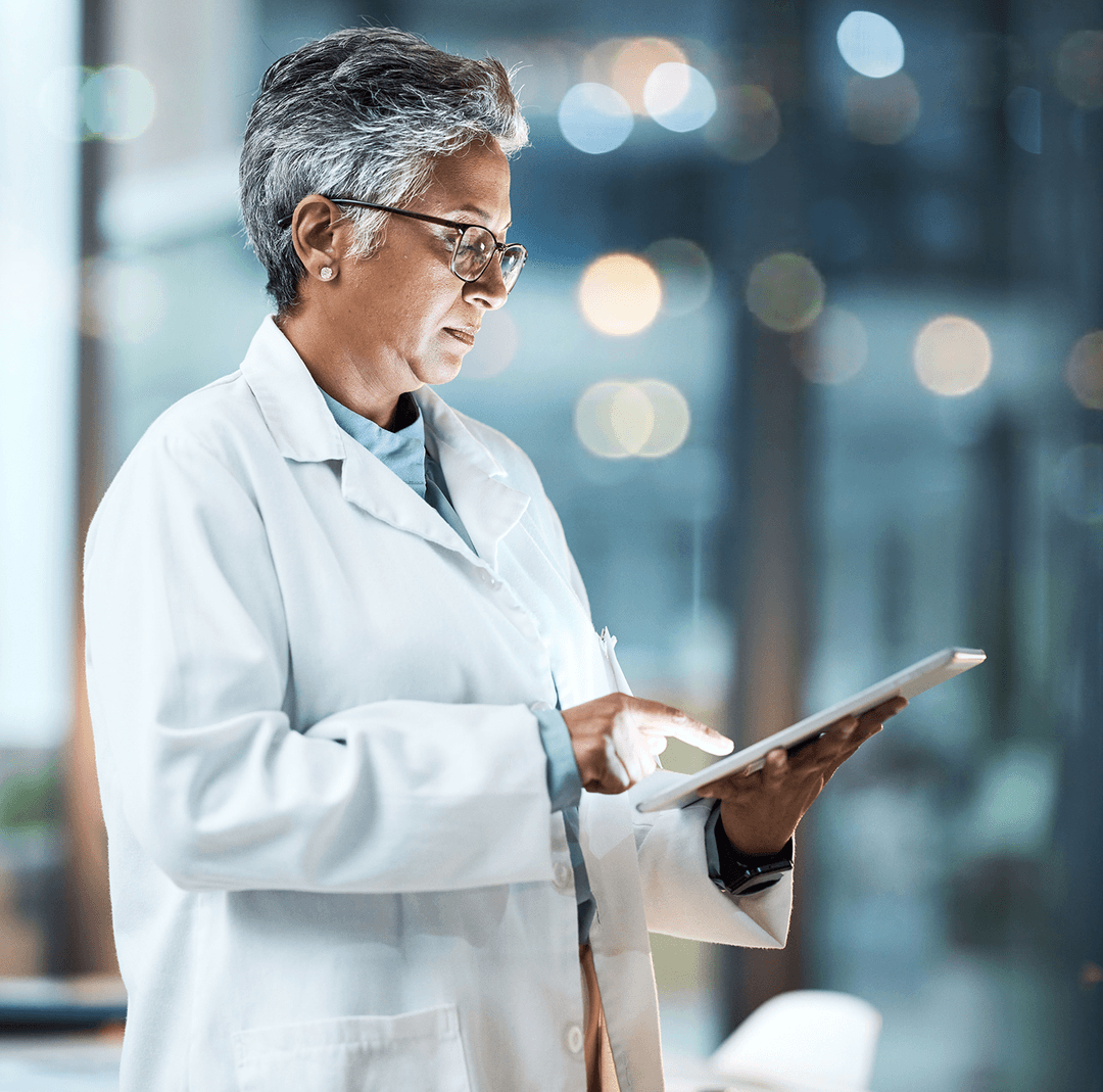 Healthcare professional reviewing patient data on a tablet
